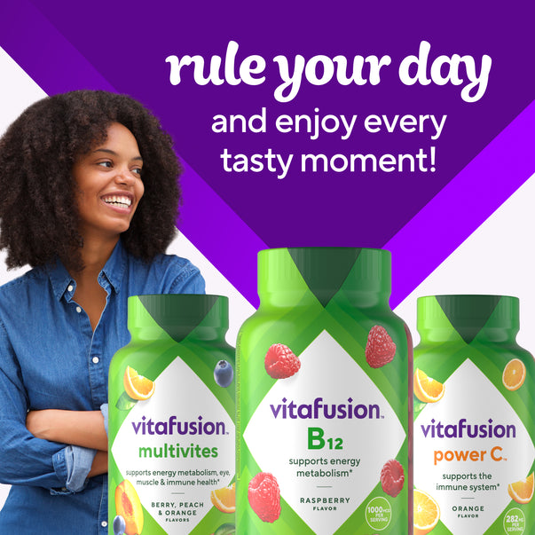 A young woman smiles next to a vitafusion B12 gummy bottle, accompanied by vitafusion Multivites and Power C bottles.